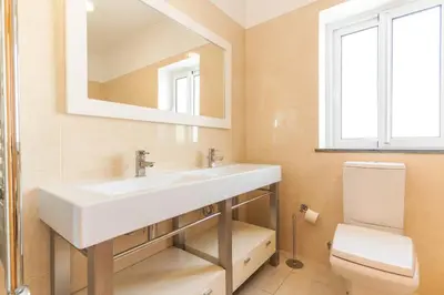 a bathroom with a white sink and a toilet at Villa Valentina by Atlantic Holiday in Ponta do Sol