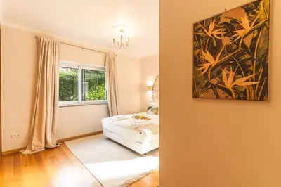 a bedroom with a bed and a painting on the wall at Villa Valentina by Atlantic Holiday in Ponta do Sol