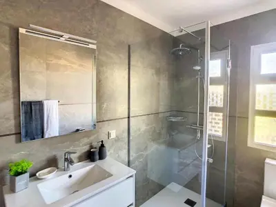 a bathroom with a sink and a shower at Villa Baradaye by Atlantic Holiday in Estreito da Calheta