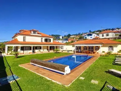 a house with a swimming pool in the yard at Villa Baradaye by Atlantic Holiday in Estreito da Calheta