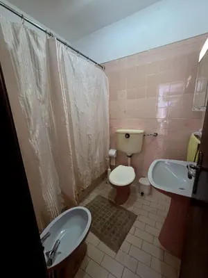 a bathroom with a toilet and a bidet and a sink at Vivenda Chagas in Luz