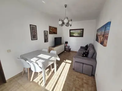 a living room with a table and a couch at Vivenda Chagas in Luz