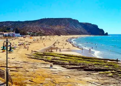 a group of people on a beach near the ocean at Vivenda Chagas in Luz
