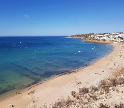 a view of a beach with people in the water at Vivenda Chagas in Luz