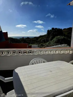 a white table and chairs on a balcony at Vivenda Chagas in Luz