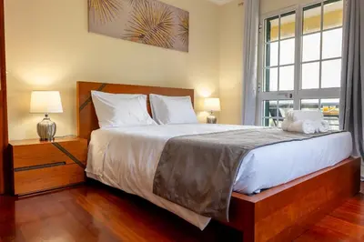 a bedroom with a large bed and a window at View to the Valley, By OP in Senhora do Rosário