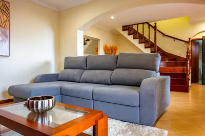 a living room with a blue couch and a table at View to the Valley, By OP in Senhora do Rosário