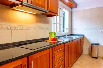 a kitchen with wooden cabinets and a sink and a window at View to the Valley, By OP in Senhora do Rosário