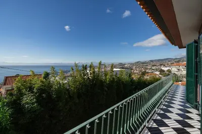 a balcony of a house with a view of the ocean at Casa da Anoneira House with Pool and Sea View in Funchal