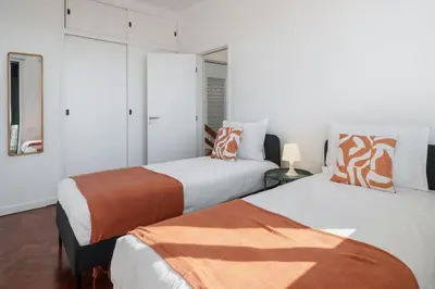 two beds in a room with white walls at Casa da Anoneira House with Pool and Sea View in Funchal