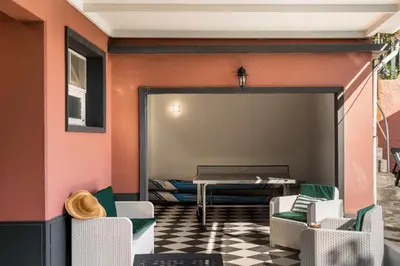 a room with a table and chairs and a room with a couch at Casa da Anoneira House with Pool and Sea View in Funchal