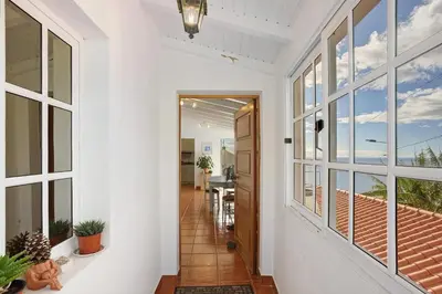 a hallway of a home with a view of the ocean at Sunset Cliffs By Slice Of Heaven in Ribeira Brava