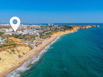 an overhead view of a beach with people and the ocean at Tenório Beach Apartment in Lagos