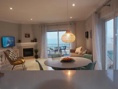 a living room with a table and a couch at Breathtaking ocean views in Praia da Luz #1992 in Luz
