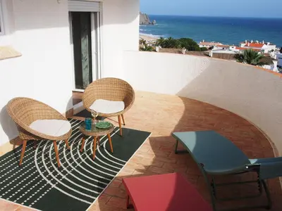 two chairs and a table on a balcony with the ocean at Breathtaking ocean views in Praia da Luz #1992 in Luz