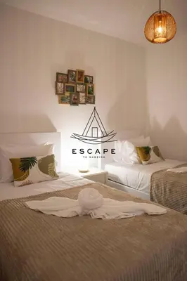 two chairs and a table in a room at Casa Alice by Escape to Madeira in Ponta do Pargo