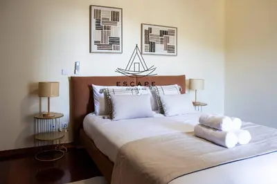a bedroom with a large bed with white pillows at Faias House by Escape to Madeira in Ribeira do Raposo