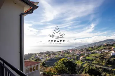 a view from the balcony of a house with a sail on it at Faias House by Escape to Madeira in Ribeira do Raposo