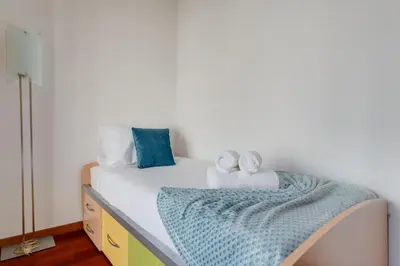 a bedroom with a bed with towels on it at Andrade's Villa by Holiday Rental Madeira in Caniço