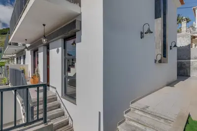a staircase leading to a house with white walls at Andrade's Villa by Holiday Rental Madeira in Caniço