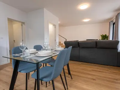 a dining room with a table and chairs and a kitchen at The Village View I, By OP in São Vicente