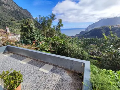 a shower with a view of the ocean and mountains at Madeira V2 Porto da Cruz in Porto da Cruz
