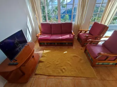 a living room with two couches and a tv at Madeira V2 Porto da Cruz in Porto da Cruz