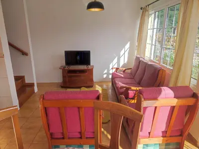 a living room with a couch and a tv at Madeira V2 Porto da Cruz in Porto da Cruz