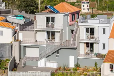 an aerial view of a white house with balconies at Casas ao Sol by An Island Apart in Ponta do Sol