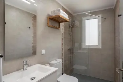a bathroom with a sink and a toilet and a shower at Casas ao Sol by An Island Apart in Ponta do Sol