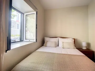 a bed in a bedroom with a window at Villa Bella Vista by AH in São Vicente