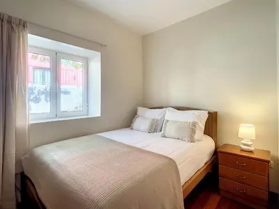 a small bedroom with a bed and a window at Villa Bella Vista by AH in São Vicente