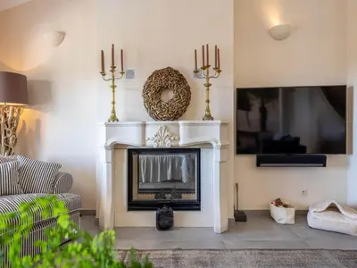 a living room with a fireplace and a tv at Private Bedroom in a Luxurious Villa, Budens in Budens