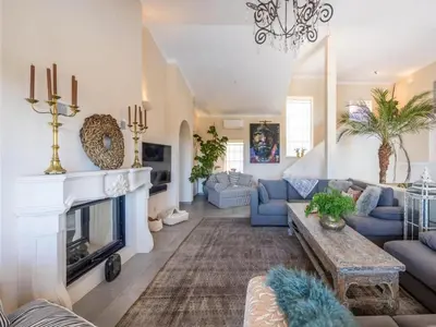 a living room with blue couches and a fireplace at Private Bedroom in a Luxurious Villa, Budens in Budens