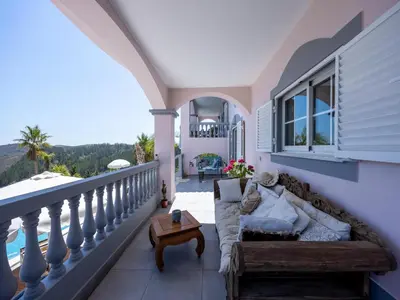 a balcony with chairs and a view of the mountains at Nice Villa in Budens with pool in Budens