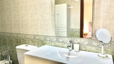 a bathroom with a sink and a mirror and a toilet at Vista Pena in Funchal