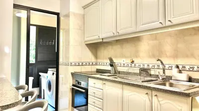 a kitchen with white cabinets and a sink at Vista Pena in Funchal