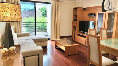 a living room with a couch and a television at Vista Pena in Funchal