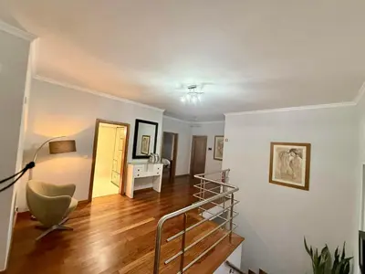 a living room with a staircase and a stair case at Vista Verde in Estreito de Câmara de Lobos