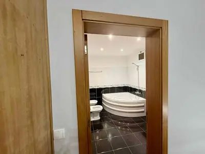 a bathroom with a toilet and a bath tub at Vista Verde in Estreito de Câmara de Lobos