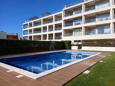 a swimming pool in front of a house at Casa Flor in Burgau
