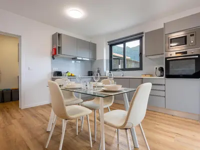 a kitchen and dining room with a table and chairs at The Village View II, By OP in São Vicente