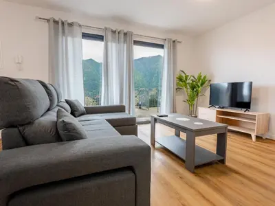 a living room with a couch and a table at The Village View II, By OP in São Vicente