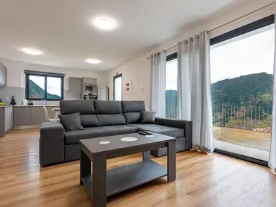 a living room with a couch and a table at The Village View II, By OP in São Vicente