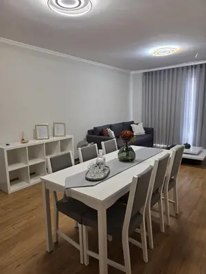 a white table and chairs in a living room at Pátio do Garajau in Caniço