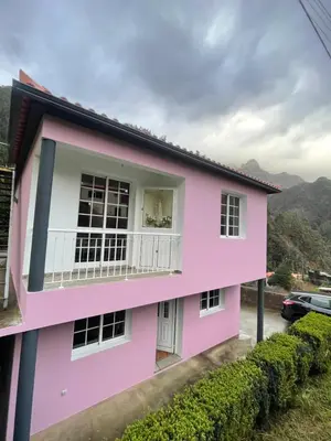 a pink house with a balcony at Forest View Countryside in Serra de Água