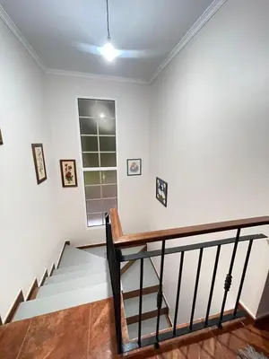 a staircase in a house with white walls at Forest View Countryside in Serra de Água