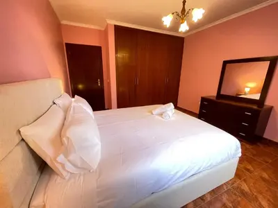 a bedroom with a white bed and a mirror at Forest View Countryside in Serra de Água