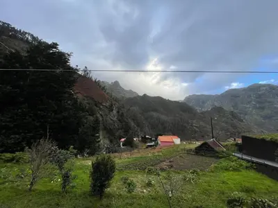 a view of a field with mountains in the background at Forest View Countryside in Serra de Água