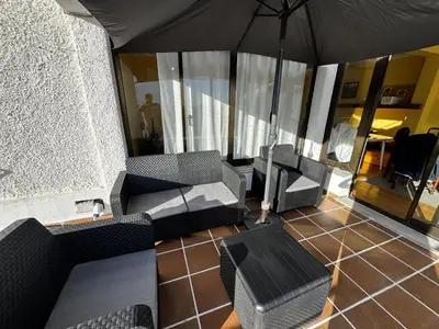 a living room with two couches and an umbrella at Machico View in Machico